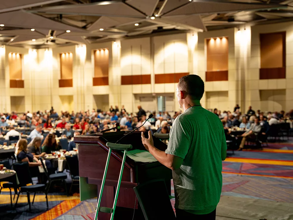 person talking at a conference about tree planting