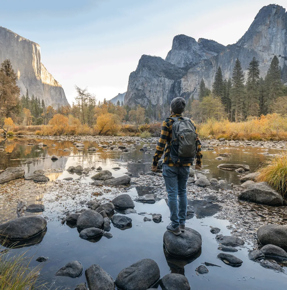 Man looking at mountain range in the distance.