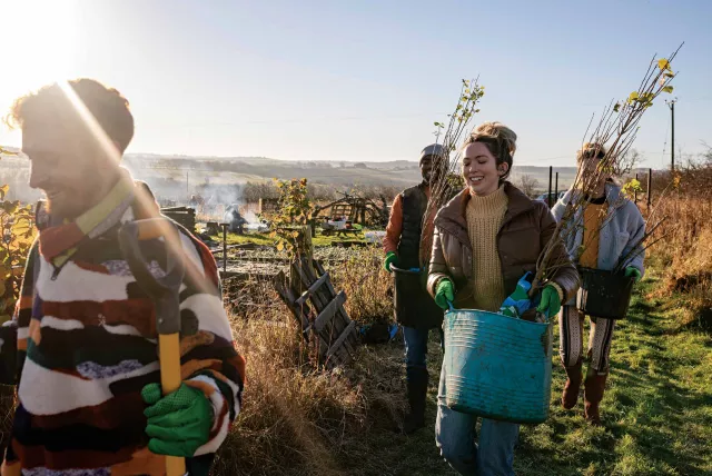 a group of volunteers working in a field.