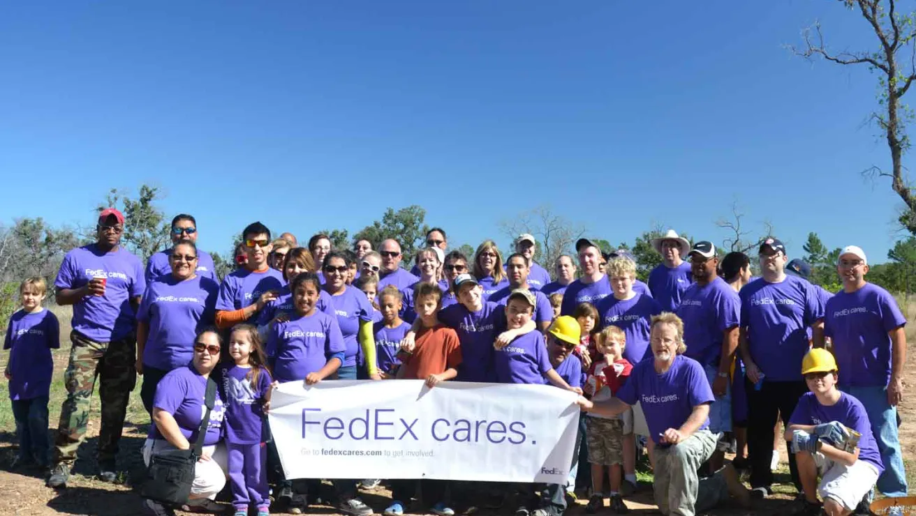 Volunteers with FedEx pose for a photo.