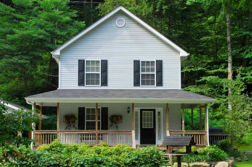 Image of a white house with wooded backyard