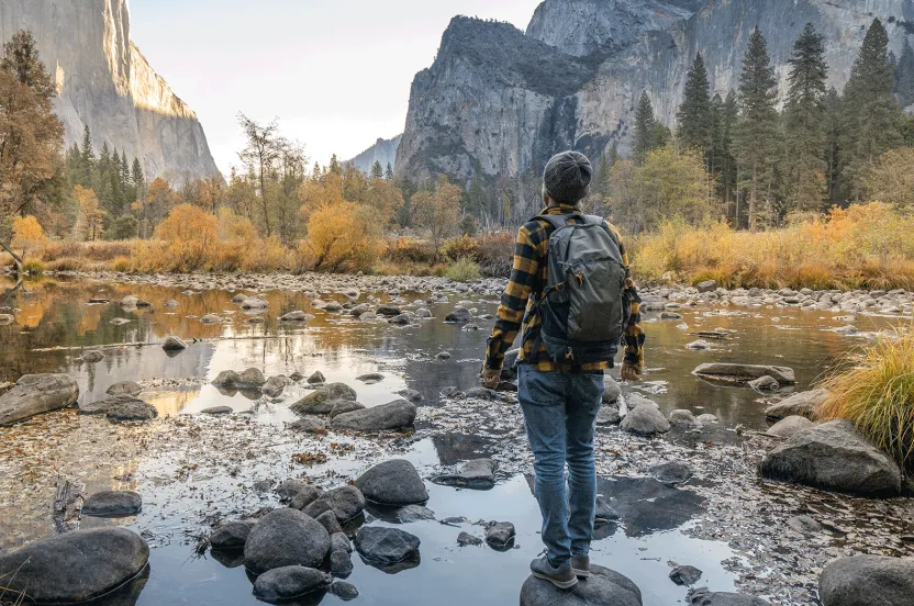 Man looking at mountain range in the distance.