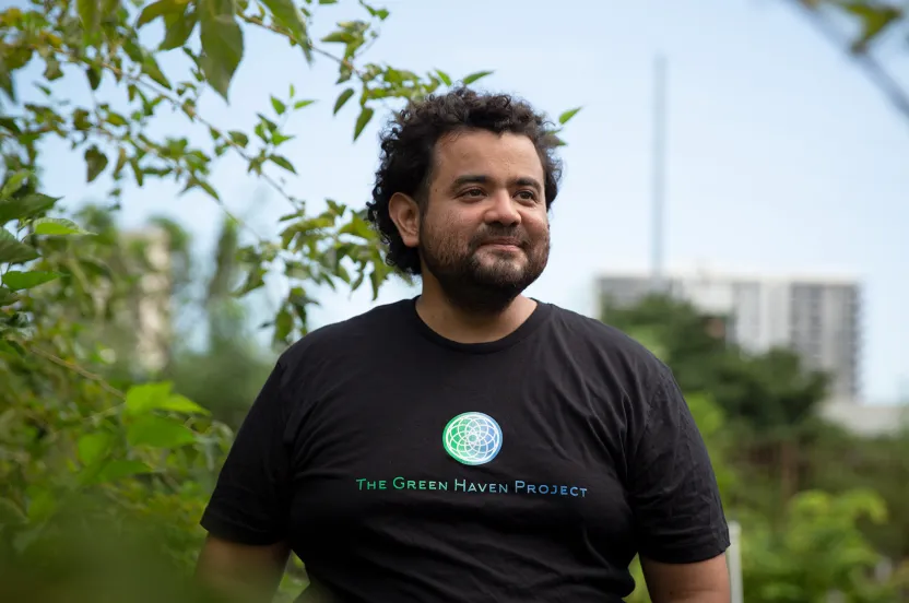 man standing and smiling in community garden in Florida.